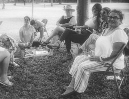 Grasveld met mensen rond een picknick